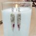 Handmade earrings with opal and quartz stones featuring wire spiral details.