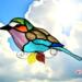 African Lilac Breasted Roller Suncatcher in direct Sunlight- made of aqua, white, brown, lavender, and turquoise glass.