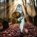 Ghost with Pumpkin stained glass suncatcher. Made of white and  orange glass with lamp worked glass leave accent.