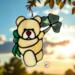 Saint Patrick's Day Bear suncatcher in direct sunlight- Cream