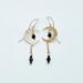 Handmade crescent moon earrings with sapphire beads and gold-filled hooks.