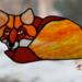 Fox Stained Glass Suncatcher by Robin C. Hary made in shades of red, orange, yellow, cream, and white glass. Hanging in full sunlight.