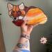Fox Stained Glass Suncatcher by Robin C. Hary made in shades of red, orange, yellow, cream, and white glass. Being held for size reference.