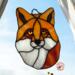 Fox Face Portrait Stained Glass Suncatcher by Robin C. Hary- made of shades of orange, red, and white glass.