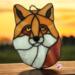 Fox Face Portrait Stained Glass Suncatcher by Robin C. Hary- made of shades of orange, red, and white glass.