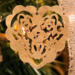 A handmade wooden Victorian-style fretwork floral heart Christmas tree ornament, featuring intricate cutout floral patterns in a heart shape, with a warm natural wood finish.