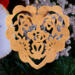A handmade wooden Victorian-style fretwork floral heart Christmas tree ornament, featuring intricate cutout floral patterns in a heart shape, with a warm natural wood finish.