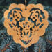 A handmade wooden Victorian-style fretwork floral heart Christmas tree ornament, featuring intricate cutout floral patterns in a heart shape, with a warm natural wood finish.