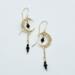 Handmade crescent moon earrings with blue sapphire beads dangling inside moon and on chain underneath