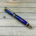 Purple and gold pinecone rollerball pen