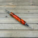 Orange and black resin double ended seam ripper
