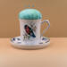 This teacup has a pincushion on the top with some pins and a saucer on the bottom to hold bobbins and other things. It is all one piece. This teacup has a pincushion on the top with some pins and a saucer on the bottom to hold bobbins and other things. It is all one piece.