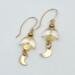 Handmade celestial earrings with glass crescent beads and gold moon dangles on 14k gold-filled wires.