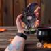 Spider the Halloween Gnome Stained Glass Suncatcher by Robin C. Hary- being held for size reference.