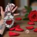 Valentine's Day Gnome "Romeo" stained glass suncatcher- by Robin C. Hary- being held for size reference.
