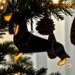 Dachshund Stained Glass Ornament by Robin C. Hary- Black and Tan shown hanging on a Christmas tree.
