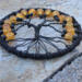 bottom view of black wire roots attached to black yarn wrapped metal hoop creating a aspooky tree of life