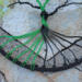 black and green aluminum wire roots attached to yarn wrapped metal hoop