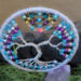 silver yarn wrapped metal hoop cradles wire tree of life. Several color seed beads adorn the branches and roots. Hematite star centers top