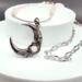 Handmade necklace with silver crescent moon pendant with rose quartz bead set inside a rose. Strung with rose quartz and pink crystal beads.