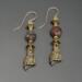 Handmade brass owl earrings with faceted petrified wood beads and gold-filled wires.