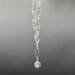 Handmade necklace with silver plated pendant set with North Star cubic zirconia on rhodium chain and hook front clasp.