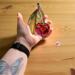 Cherry stained glass ornament being held for size reference. Approximately 4" by 4".