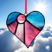 Heart-sun stained glass oranemtn- in shades of purple/pink and the top half in a blue sky glass.