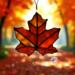 Sugar Maple Leaf Ornament- made of a glass that has red, orange and yellow swirled within it, giving the look of a real sugar maple leaf.