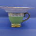 Looking straight at it, you can see the pearls around the base of the cup and the pearl flower peeking over the saucer.  Looking straight at it, you can see the pearls around the base of the cup and the pearl flower peeking over the saucer.