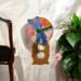 Dragonfly Stained Glass Night Light- in green and blue iridescent glass with yellow, orange mottle glass backdrop.