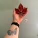 Red Maple Leaf stained glass ornament being held for size reference. Approximately 4" x 4".