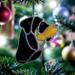 Rottweiler stained glass ornament by Robin C. Hary hanging on a Christmas Tree.