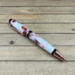 White and copper resin swirled cigar style ballpoint pen