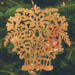 A handcrafted Victorian-style wooden Christmas tree ornament shaped like a basket filled with intricate floral designs, featuring detailed leaves and blossoms, with a small hook at the top for hanging.