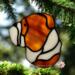 Bulldog stained glass ornament in Fawn shown hanging on a Christmas tree.