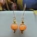 Festive handmade orange agate pumpkin-shaped earrings with gold accents and 14k gold-filled wires, about 2 inches long.