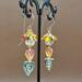 Handmade Czech glass leaf earrings with glass bicones in fall colors on 14k gold-filled wires, about 2 inches long.