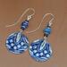 Handmade blue embossed pewter earrings with lapis lazuli beads and glass accents, just over 2 inches long.