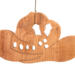 Handmade wooden Christmas tree ornament shaped like a cowboy hat, featuring a sprig of holly tucked into the hat band, star-shaped leaf cutouts, and round berry accents.