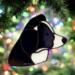 Border Collie stained glass ornament shown in Black and White- hanging on a Christmas Tree.