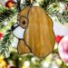 Cavalier King Charles Spaniel stained glass ornament shown in Blenheim hanging from a Christmas tree.