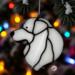 Great Pyrenees stained glass ornament hanging on a Christmas tree.