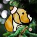 Pit Bull Stained Glass Ornament- shown in tan hanging on a Christmas Tree.