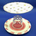This lollypop jewelry dish has a dark pink and white dish on the bottom with pearls surrounding the crystal goblet. This lollypop jewelry dish has a dark pink and white dish on the bottom with pearls surrounding the crystal goblet.