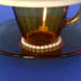 The base of the demitasse cup and saucer with more pearls . The base of the demitasse cup and saucer with more pearls .