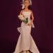 11.5 inch fashion doll wearing white sheath style wedding dress, birdcage veil and holding a bouquet of white lillies