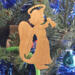 A handmade wooden Christmas ornament in the shape of a cheerful angel, featuring a halo, wings, and a raised arm ringing a bell, hand-cut from solid hardwood and finished with clear shellac.