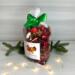 Irish Twins Apple Cinnamon Potpourri bag with green ribbon, pine branches, and small twinkling lights.