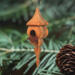 Handcrafted miniature wooden birdhouse ornament shaped like an icecicle with a pointed roof and base, featuring a rounded entrance hole and a perched bird, and made from reclaimed hardwoods finished with a satin shellac.